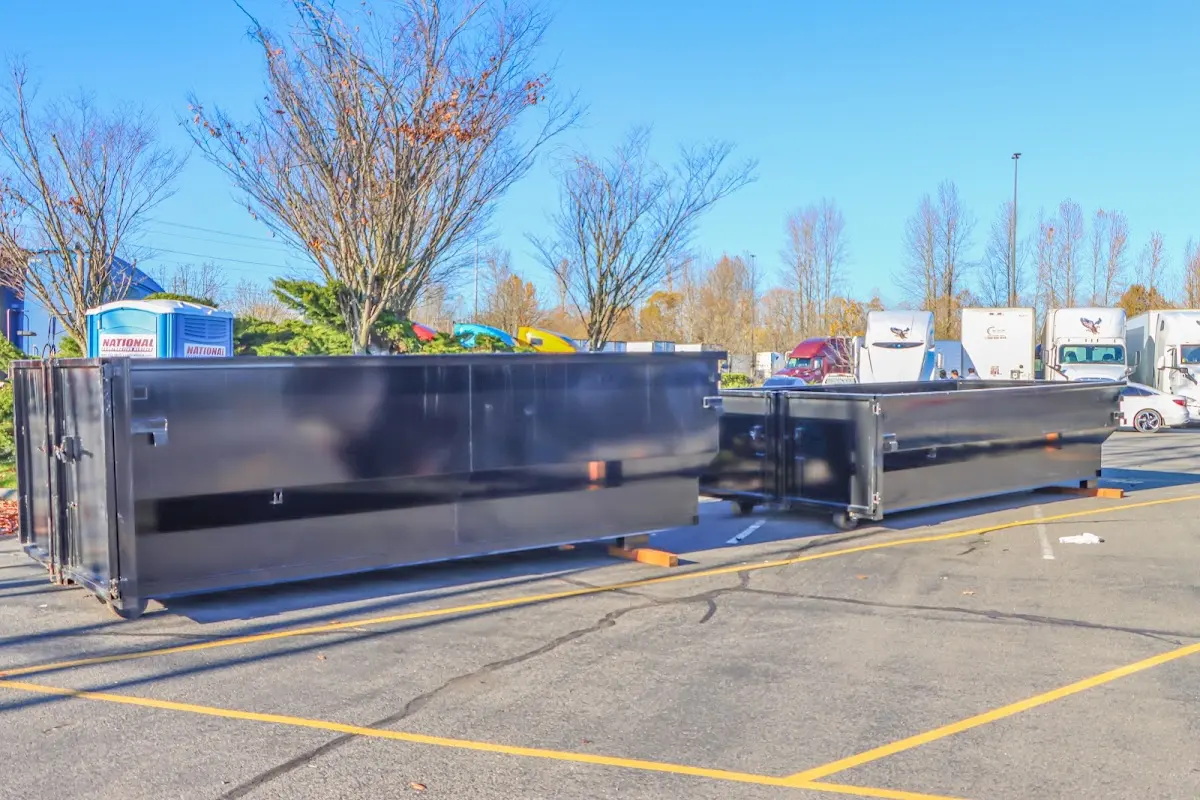 Professional dumpster rental service with roll-off container on residential driveway in Atascocita